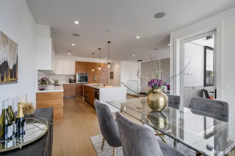 a living room with furniture and kitchen view