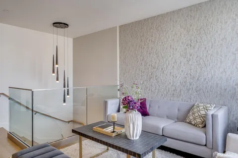 a living room with furniture and flowers