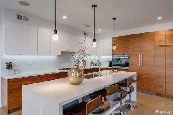 a kitchen with a table a stove and cabinets