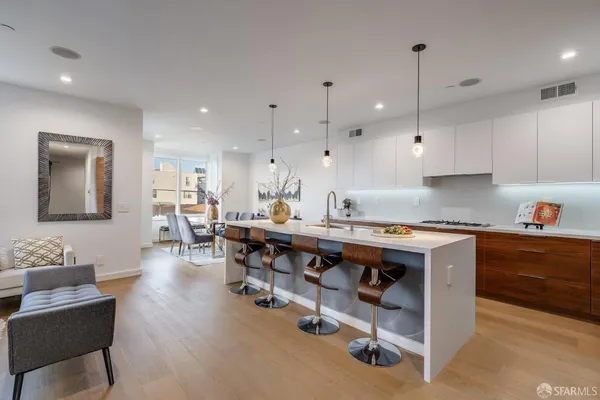 a large kitchen with lots of counter space and furniture