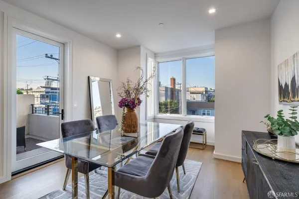a dining room with furniture and wooden floor