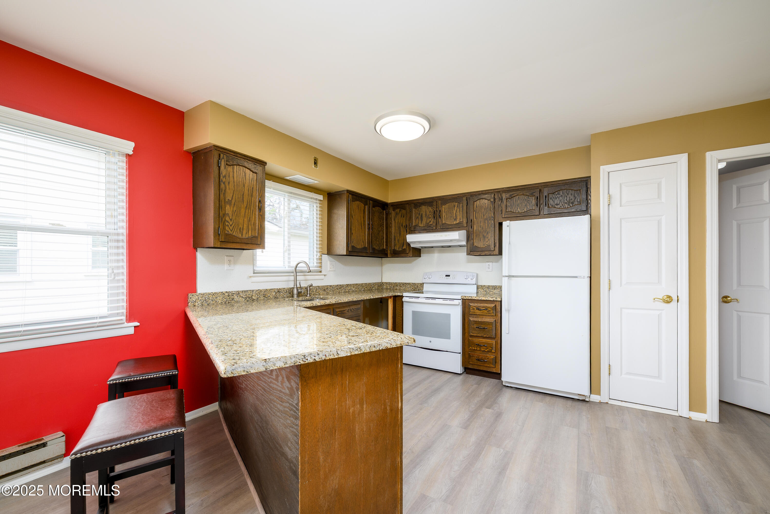 27 Blake Circle Brick, NJ 08724 - Photo 11 of 39 a kitchen with stainless steel appliances granite countertop a refrigerator a sink dishwasher a stove and white countertops with wooden floor