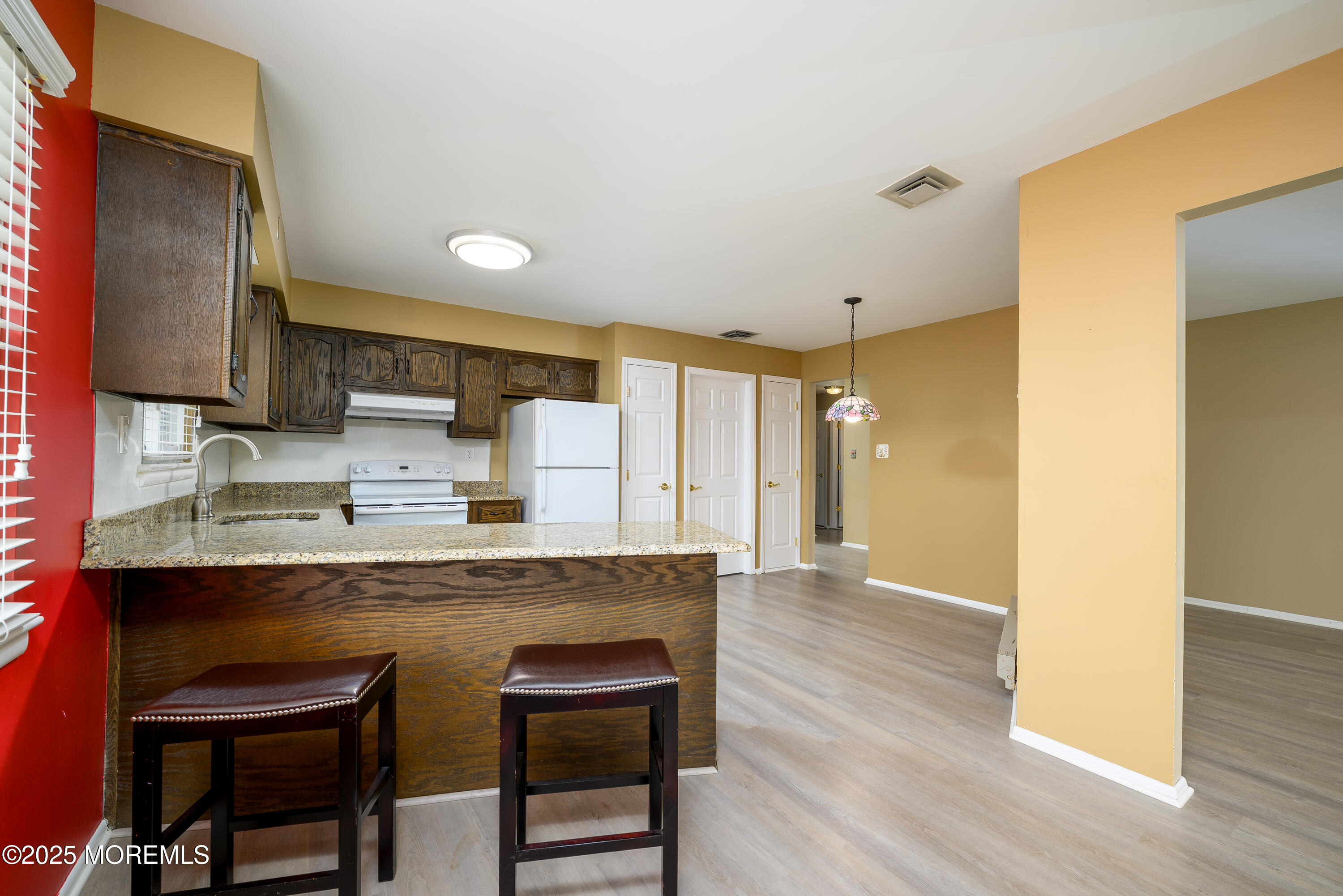 27 Blake Circle Brick, NJ 08724 - Photo 15 of 39 a kitchen with kitchen island a sink cabinets and wooden floor