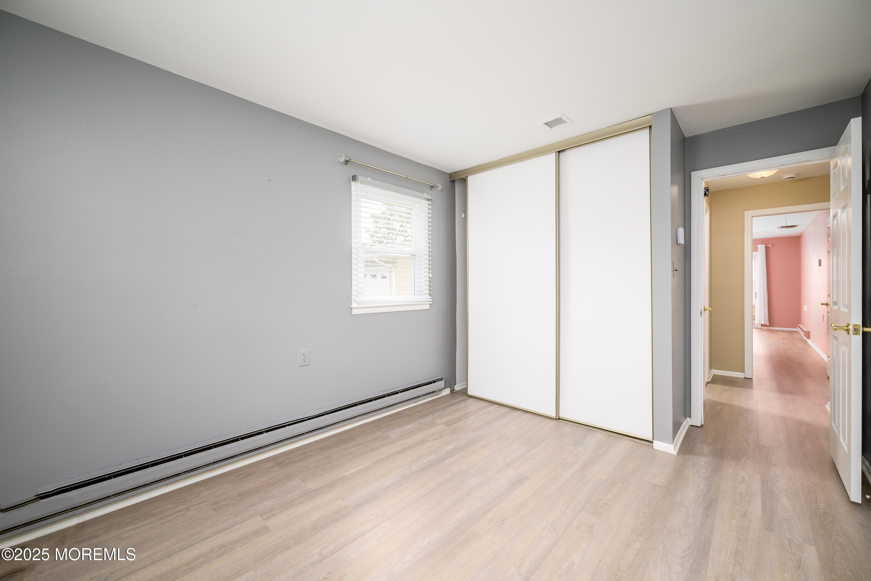 27 Blake Circle Brick, NJ 08724 - Photo 27 of 39 an empty room with wooden floor and windows