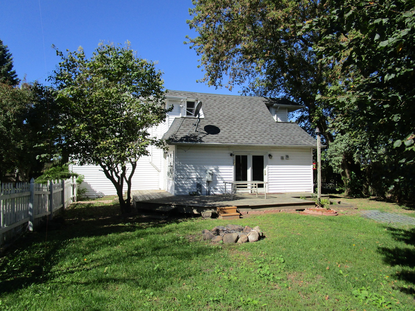 19882 McGuire Road Harvard, IL 60033 - Photo 2 of 17 a front view of house with yard and trees