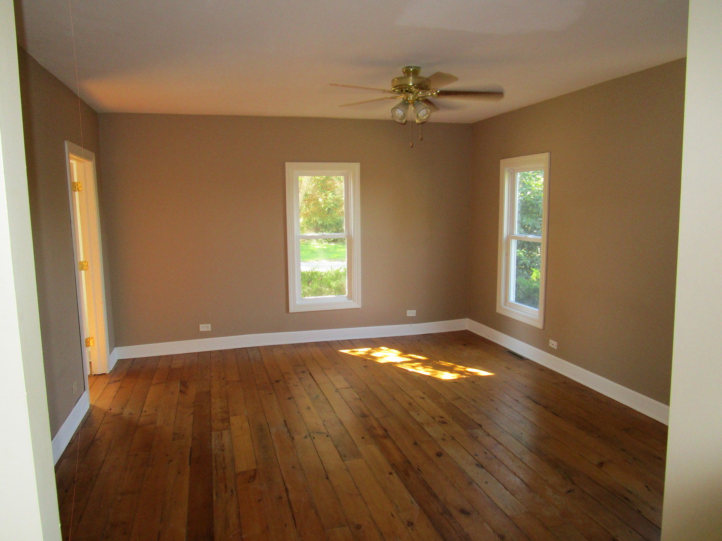 19882 McGuire Road Harvard, IL 60033 - Photo 16 of 17 a view of an empty room with wooden floor and a window