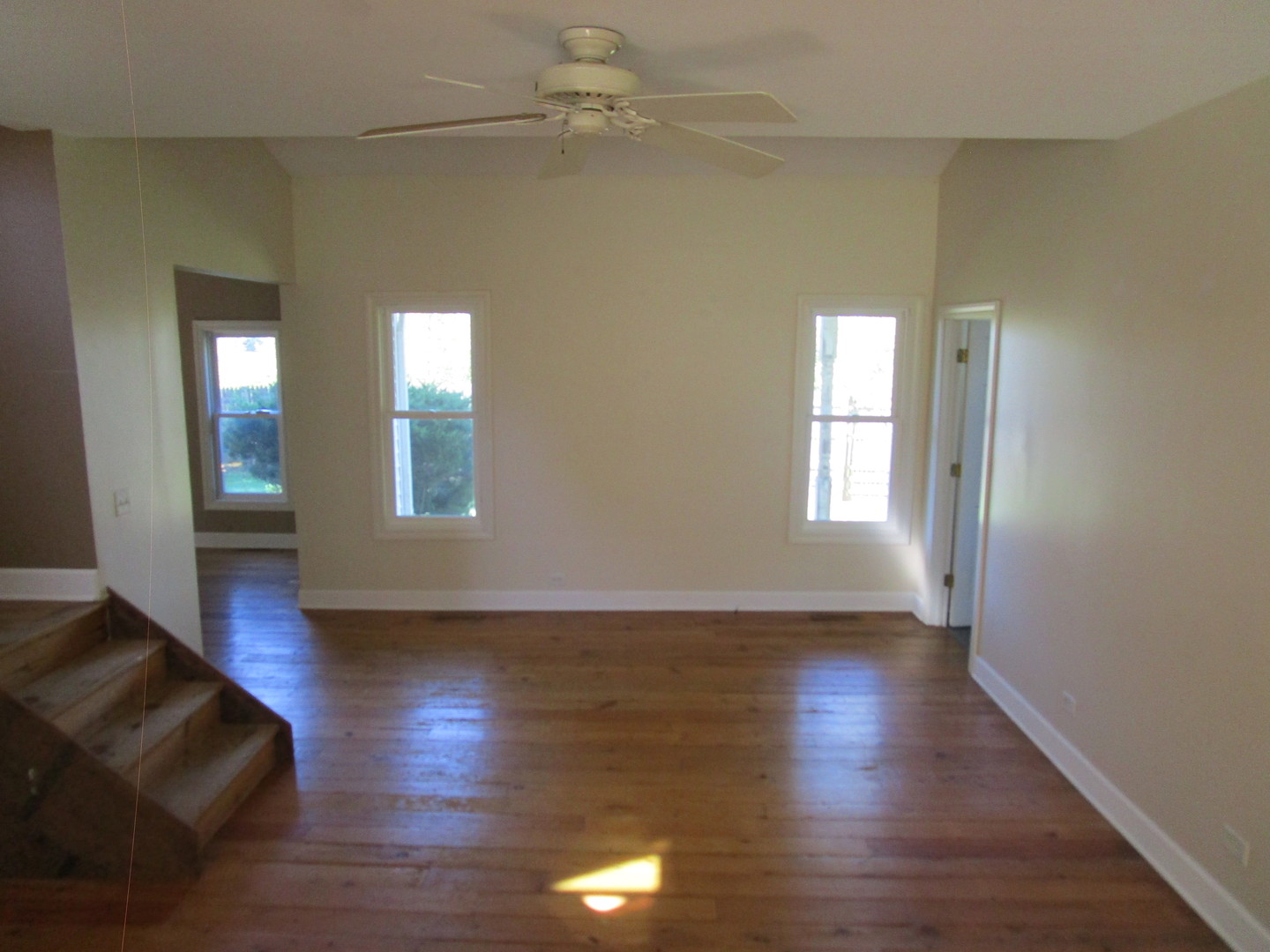 19882 McGuire Road Harvard, IL 60033 - Photo 17 of 17 an empty room with wooden floor and windows