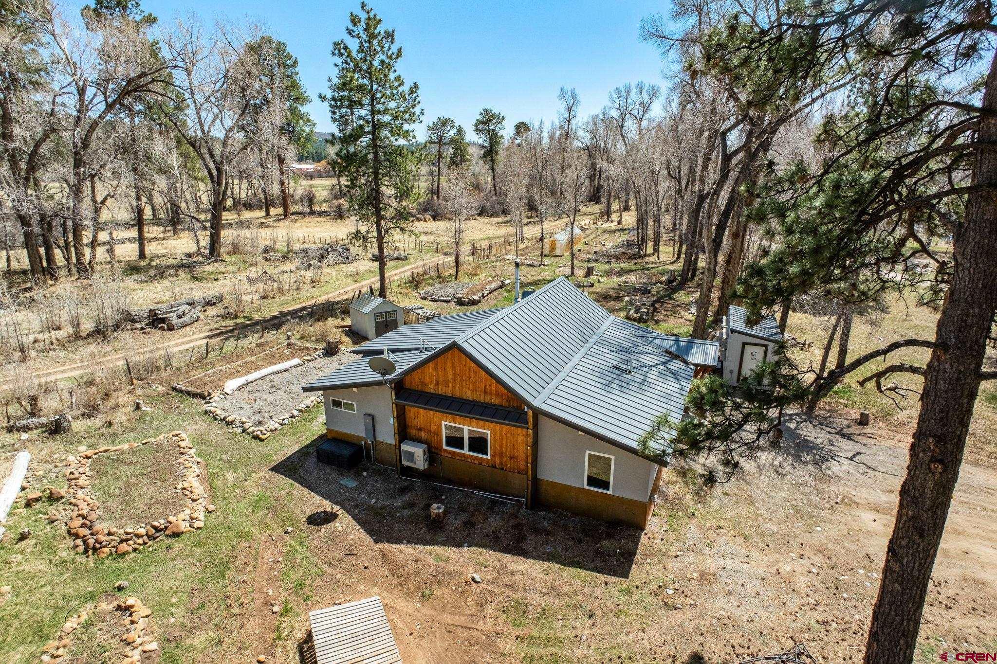a view of a house with a yard covered in snow