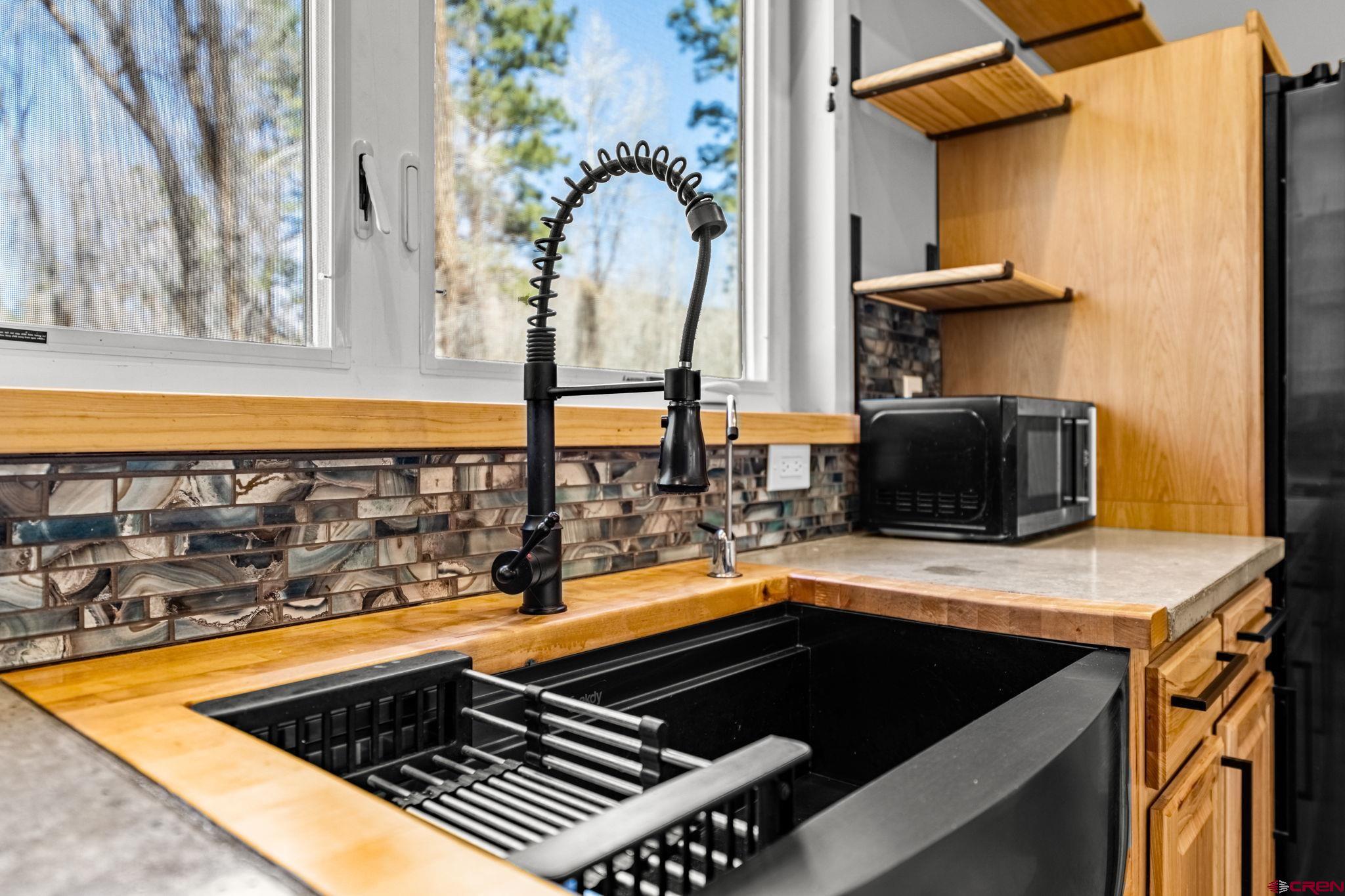 124 Richards Drive Bayfield, CO 81122 - Photo 12 of 42 a view of a kitchen with a sink and a table and chairs