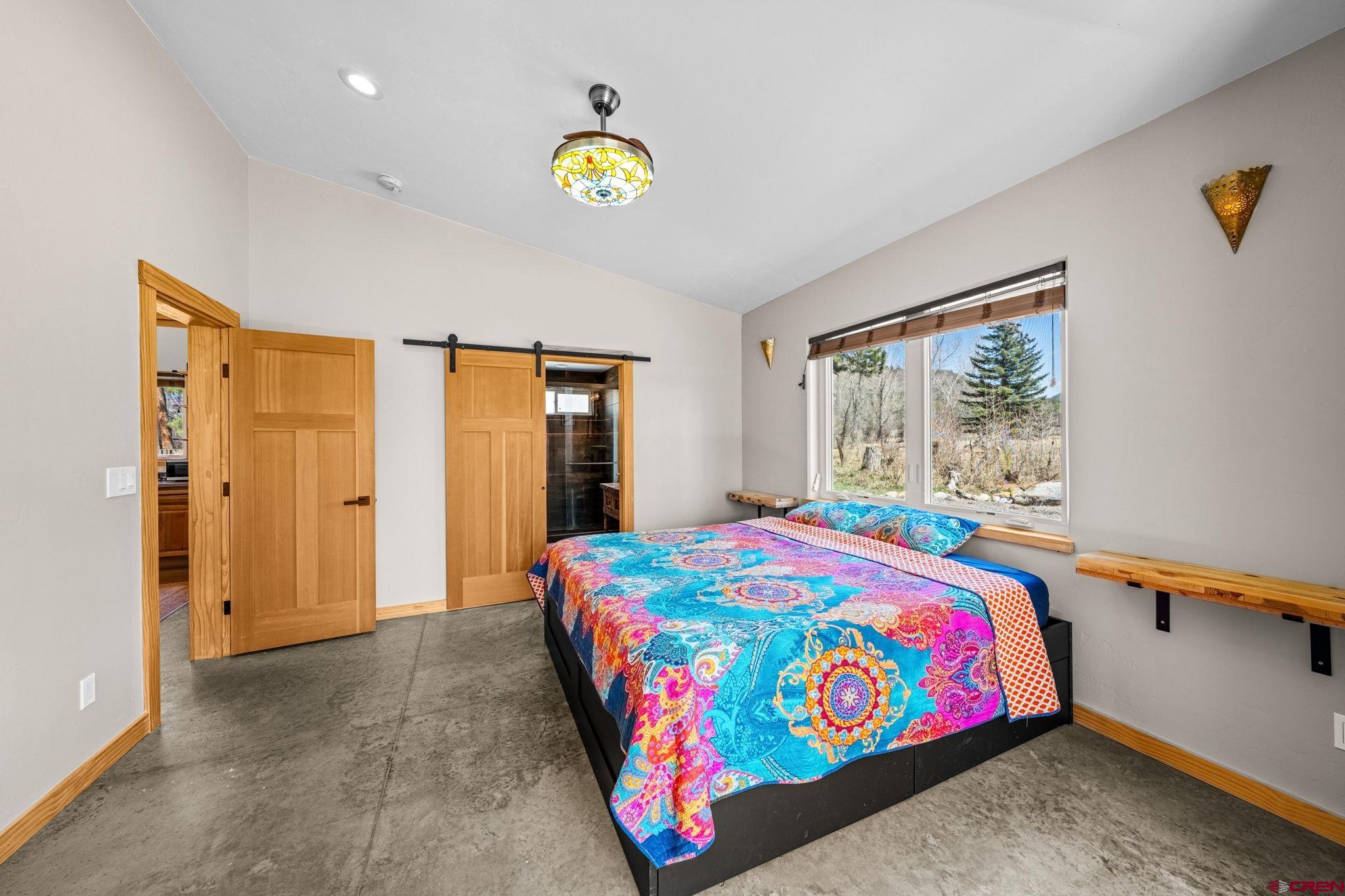 124 Richards Drive Bayfield, CO 81122 - Photo 17 of 42 a bedroom with a bed and a window