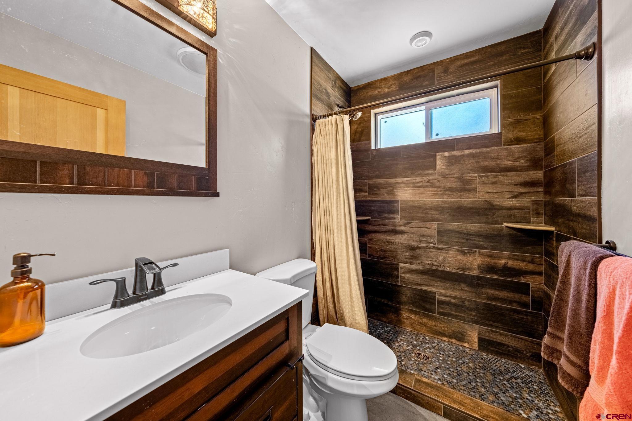 124 Richards Drive Bayfield, CO 81122 - Photo 23 of 42 a bathroom with a sink a toilet and shower