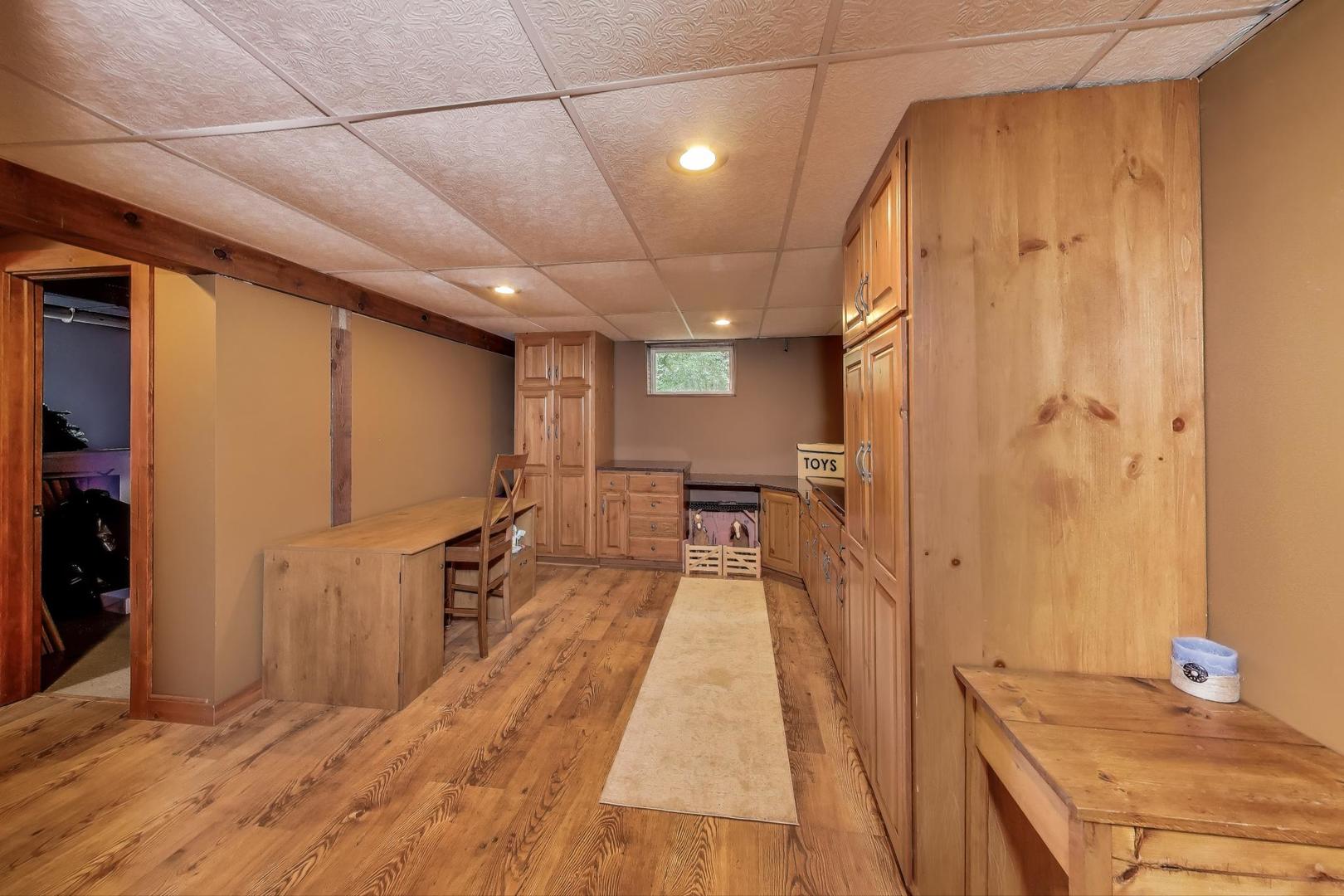 19542 Bauer Road Custer Park, IL 60481 - Photo 23 of 42 a hallway with a wooden floor and a bathroom
