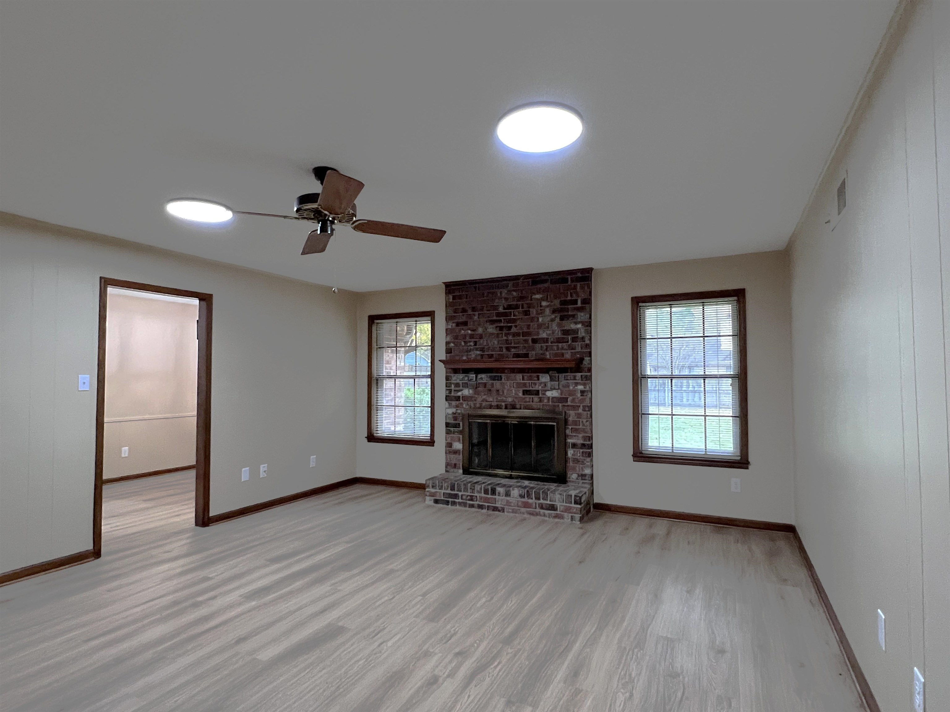 309 West Powell Road Collierville, TN 38017 - Photo 12 of 40 a view of empty room with a fireplace and wooden floor
