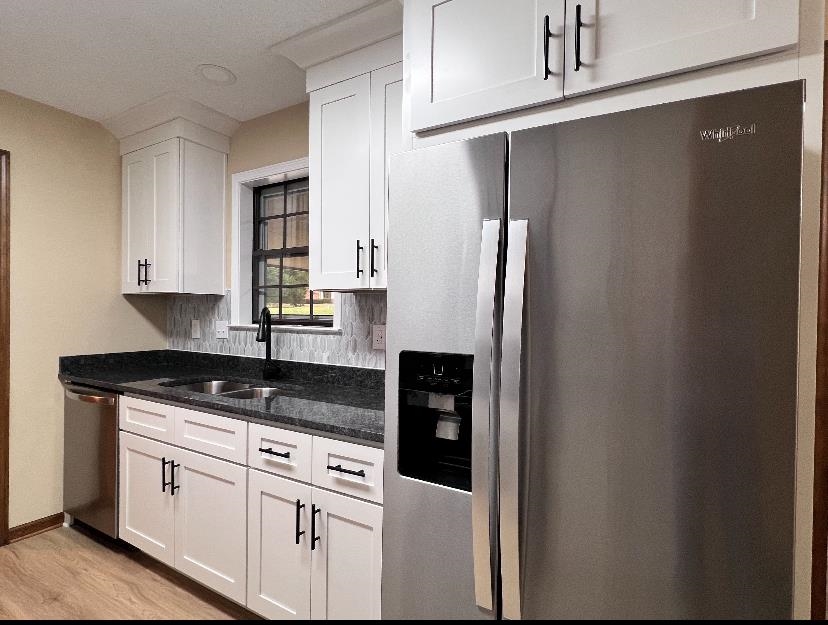 309 West Powell Road Collierville, TN 38017 - Photo 6 of 40 a kitchen with stainless steel appliances granite countertop a refrigerator and a stove