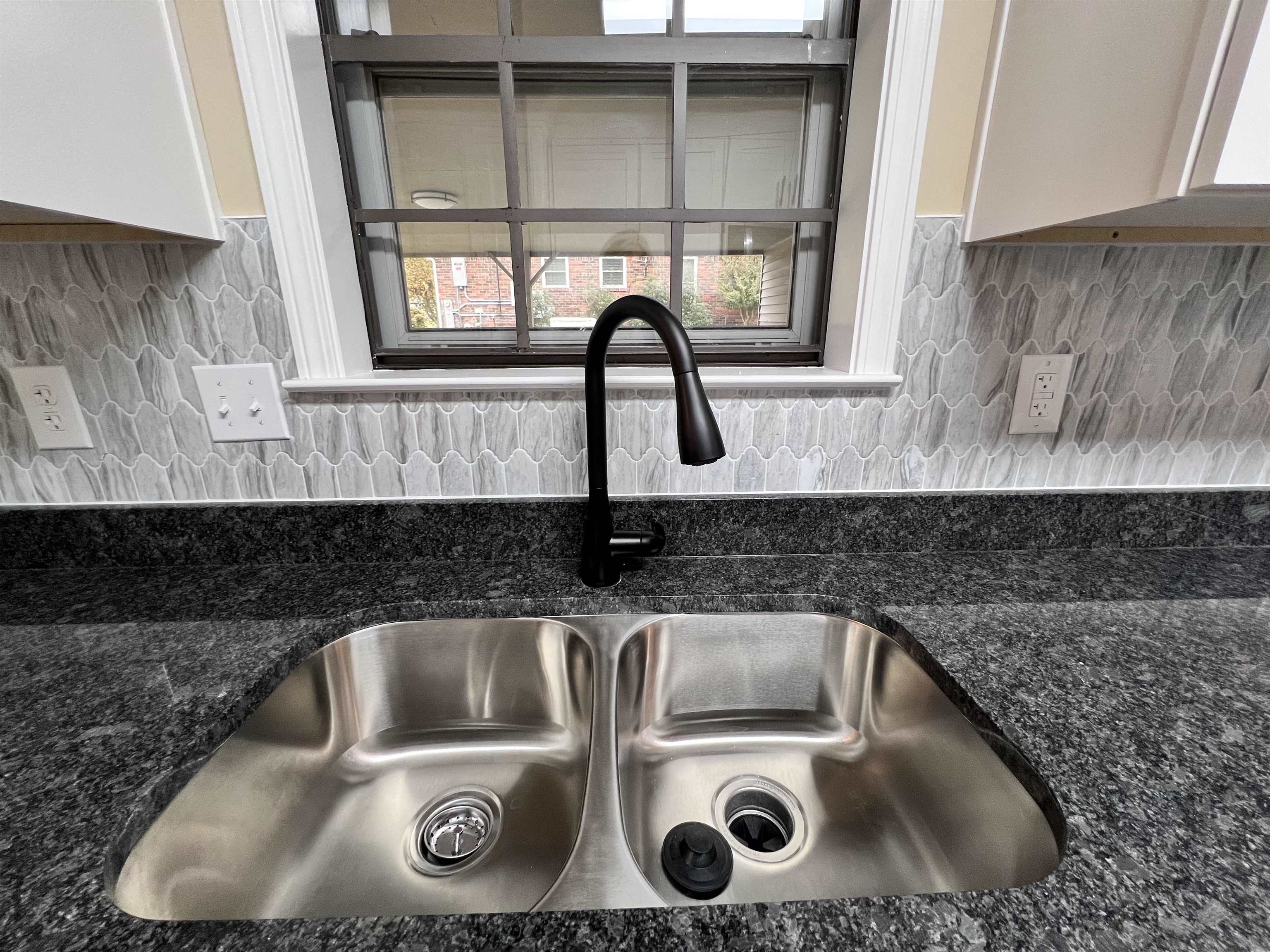 309 West Powell Road Collierville, TN 38017 - Photo 10 of 40 a kitchen with a sink and a window
