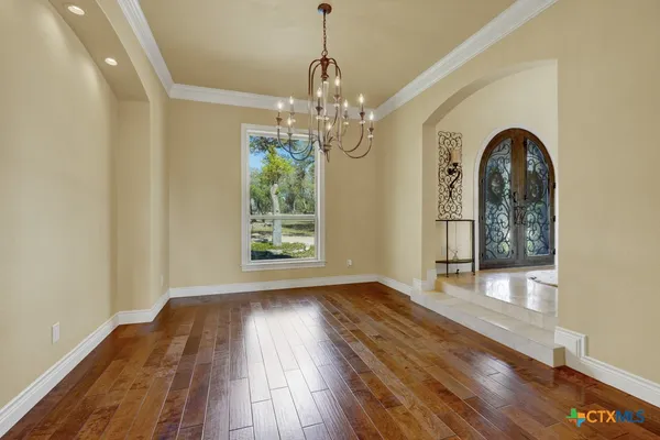 an aerial view of a house with yard and seating space