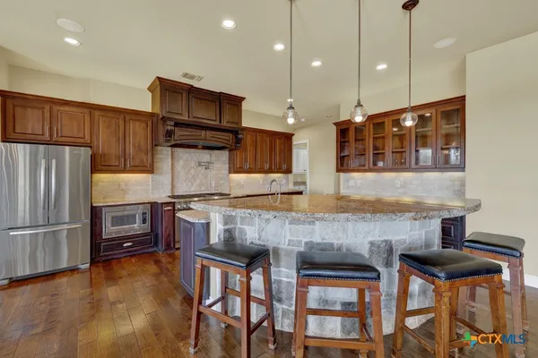 a backyard of a house with lots of green space and fountain