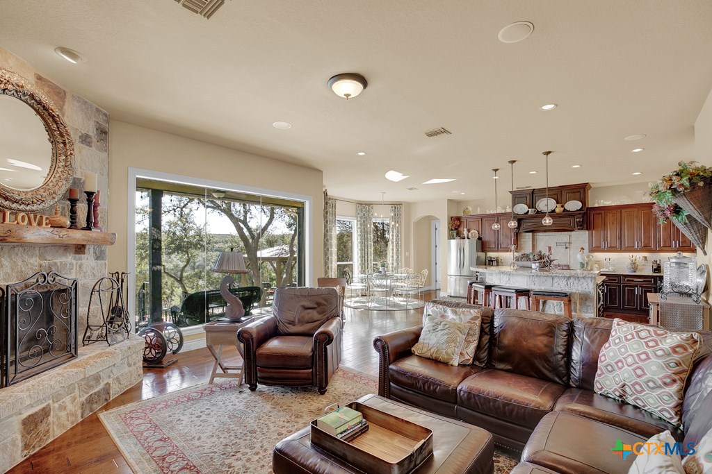 1262 Elm Creek Road New Braunfels, TX 78132 - Photo 17 of 48 a living room with furniture and a fireplace