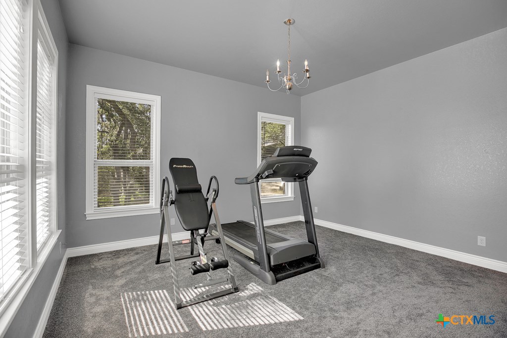 1262 Elm Creek Road New Braunfels, TX 78132 - Photo 20 of 48 a view of a workspace with furniture and a window