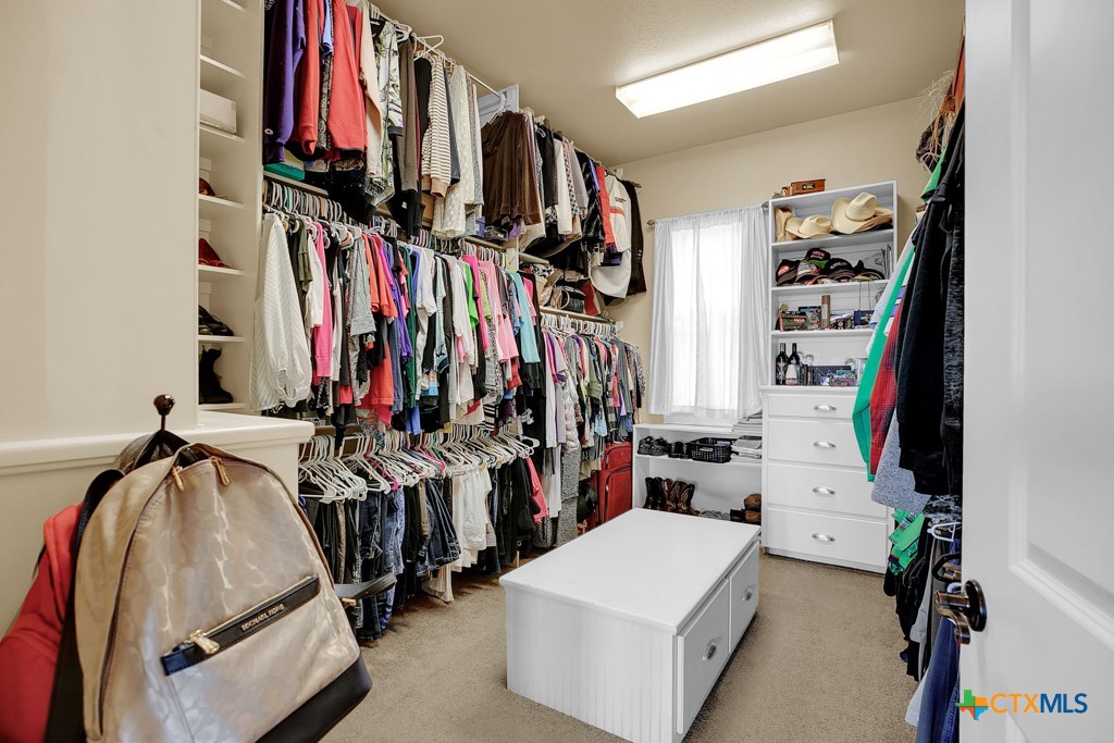 1262 Elm Creek Road New Braunfels, TX 78132 - Photo 26 of 48 a view of walk in closet with clothes and shoes