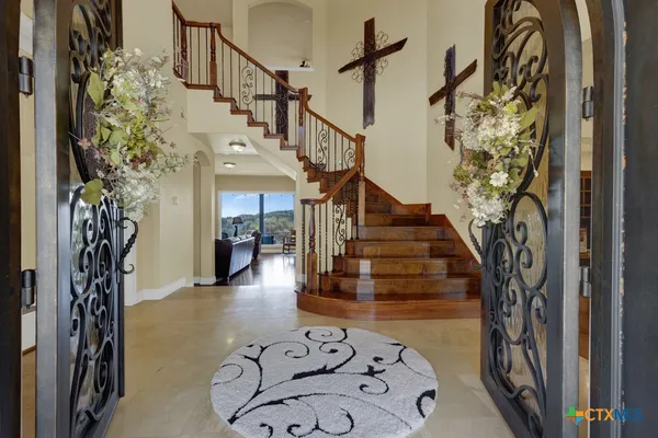 a front view of house with yard and trees in the background