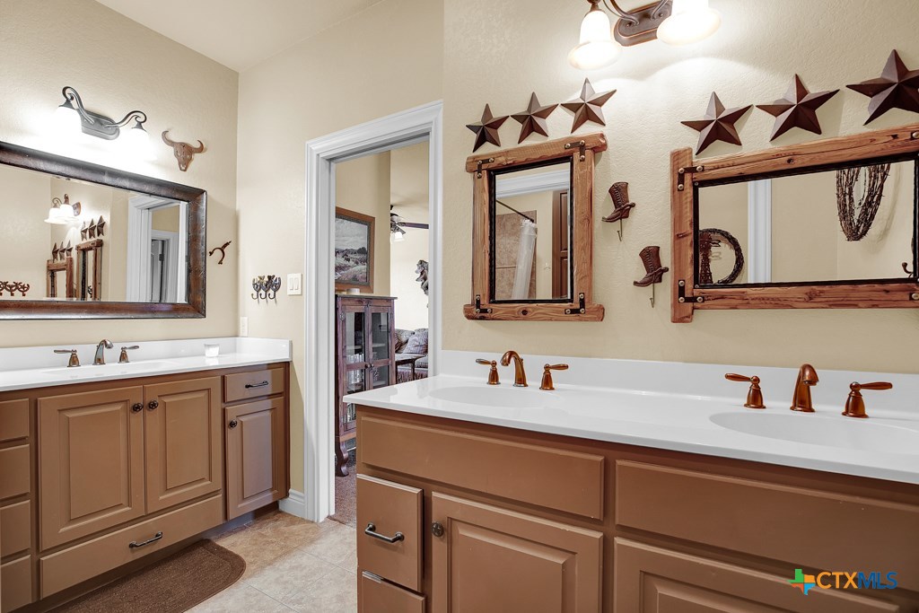 1262 Elm Creek Road New Braunfels, TX 78132 - Photo 37 of 48 a bathroom with a double vanity sink and a mirror