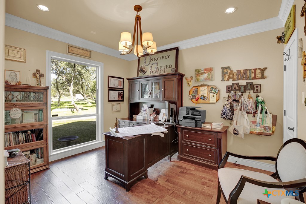 1262 Elm Creek Road New Braunfels, TX 78132 - Photo 8 of 48 a view of a workspace with furniture and a window