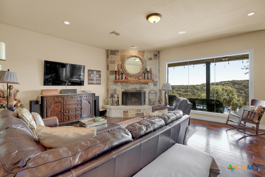 1262 Elm Creek Road New Braunfels, TX 78132 - Photo 9 of 48 a living room with fireplace furniture and a flat screen tv