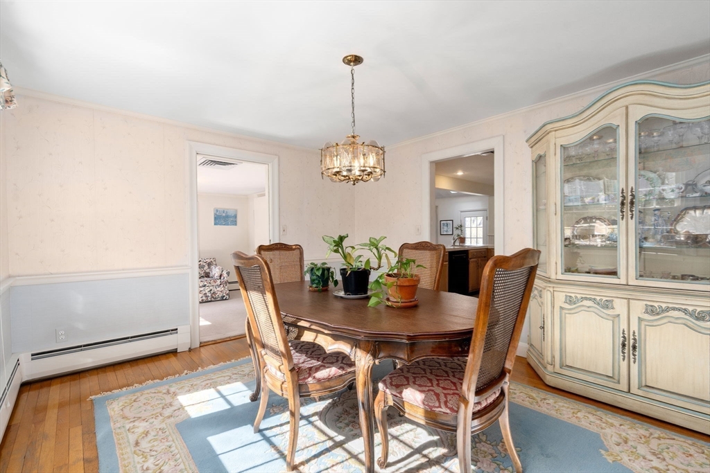 3 Tower Road Lexington, MA 02421 - Photo 12 of 38 a dining room with furniture a chandelier and wooden floor