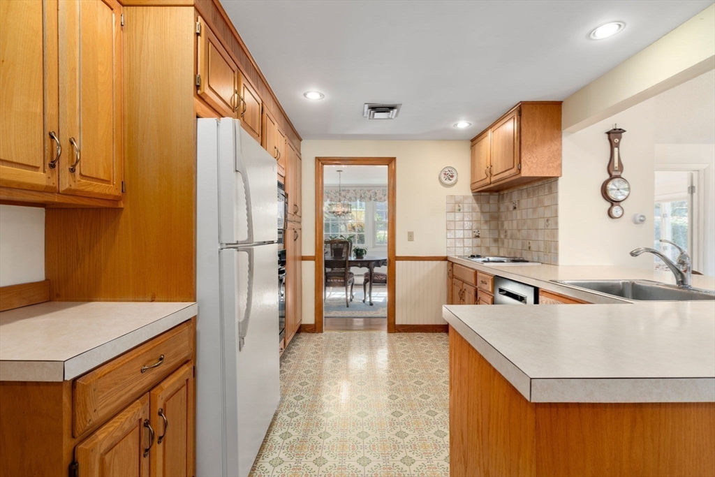 3 Tower Road Lexington, MA 02421 - Photo 17 of 38 a kitchen with stainless steel appliances granite countertop a sink dishwasher stove and refrigerator