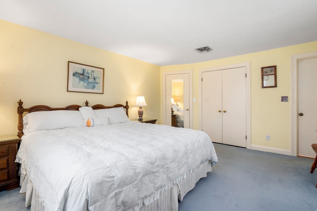3 Tower Road Lexington, MA 02421 - Photo 23 of 38 a bedroom with bed and paintings on the wall
