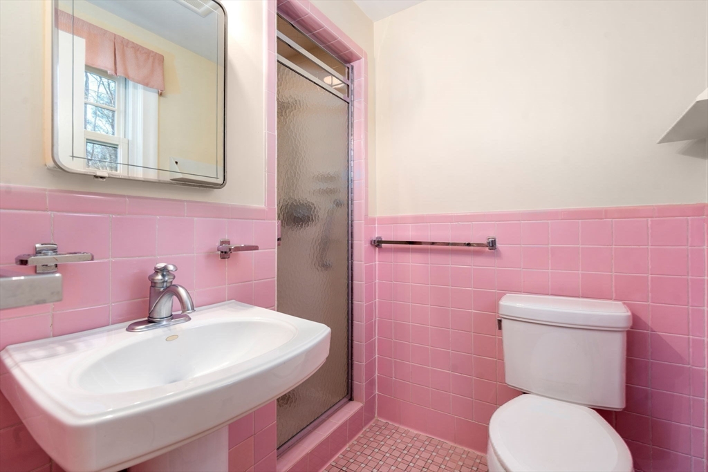 3 Tower Road Lexington, MA 02421 - Photo 24 of 38 a bathroom with a sink a toilet and a mirror