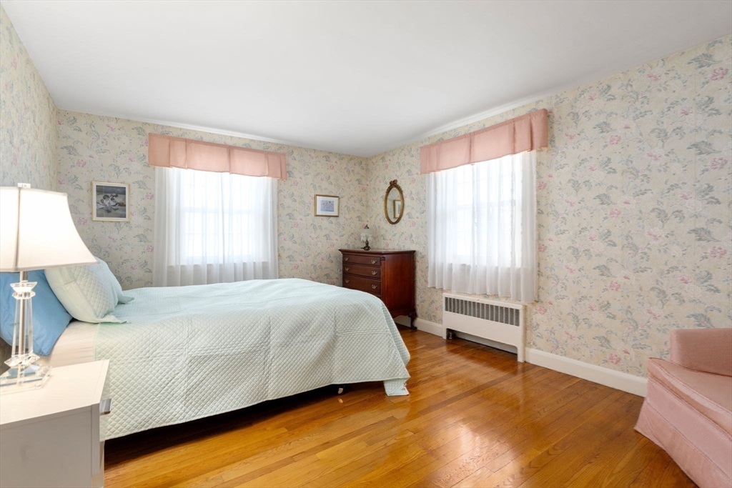 3 Tower Road Lexington, MA 02421 - Photo 25 of 38 a bedroom with a bed and wooden floor