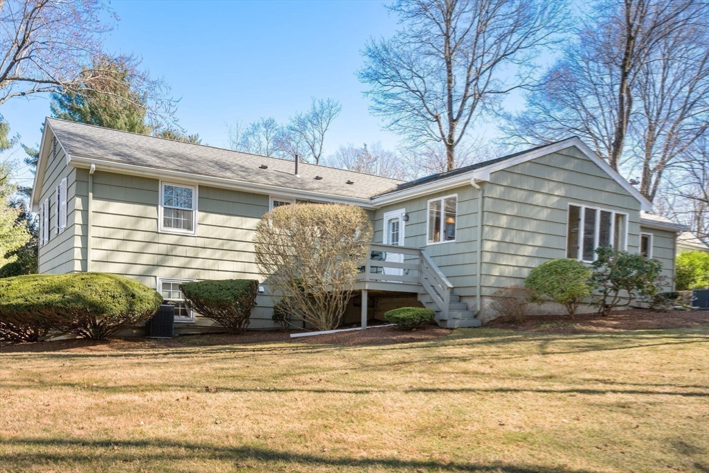 3 Tower Road Lexington, MA 02421 - Photo 35 of 38 a front view of a house with a yard and potted plants