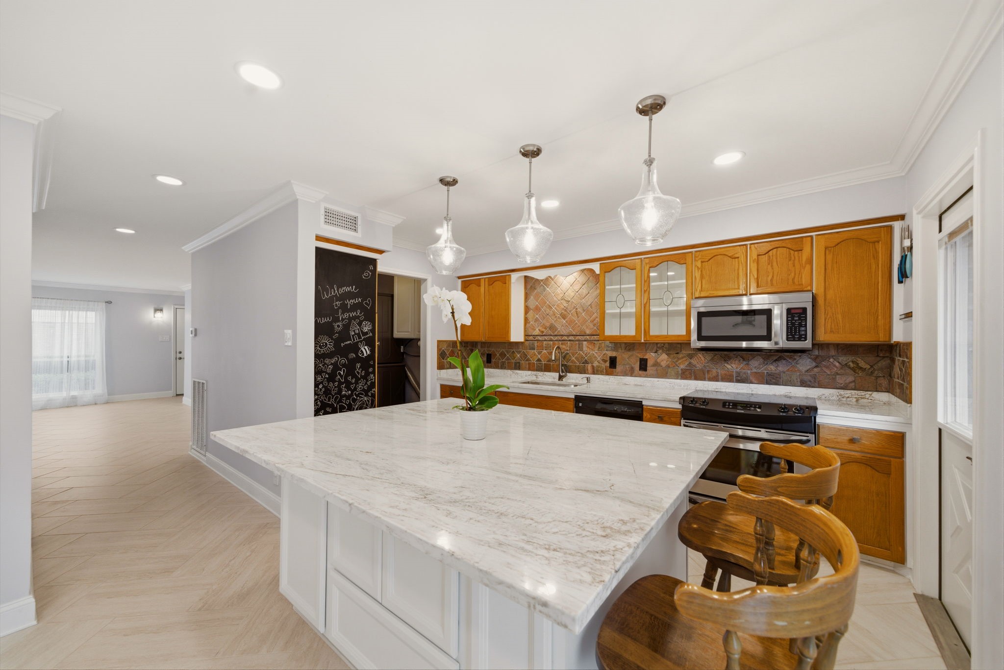 6452 Burgoyne Road, Unit 100 Houston, TX 77057 - Photo 12 of 44 a kitchen with stainless steel appliances granite countertop a sink and a refrigerator