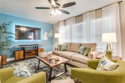 a living room with furniture and a flat screen tv