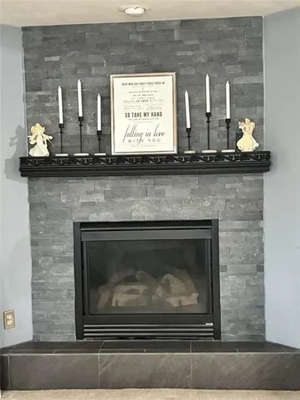 a closeup of a fireplace with a window