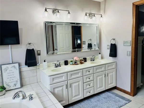 a bathroom with a double vanity sink and mirror