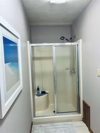 a bathroom with a glass shower door
