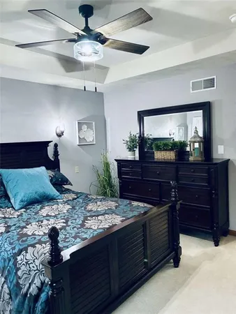 a bedroom with a bed and a dresser