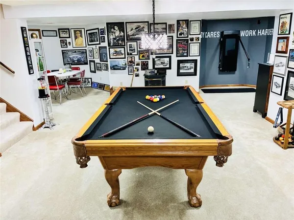 a room with pool table and a flat screen tv