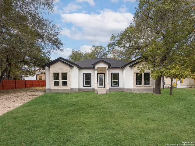 a front view of house with yard and green space