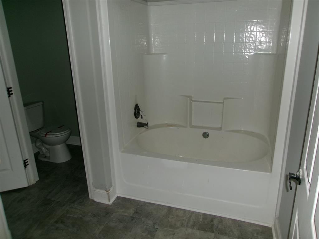 810 Williams Road Converse, LA 71419 - Photo 11 of 15 a white bath tub sitting next to a toilet