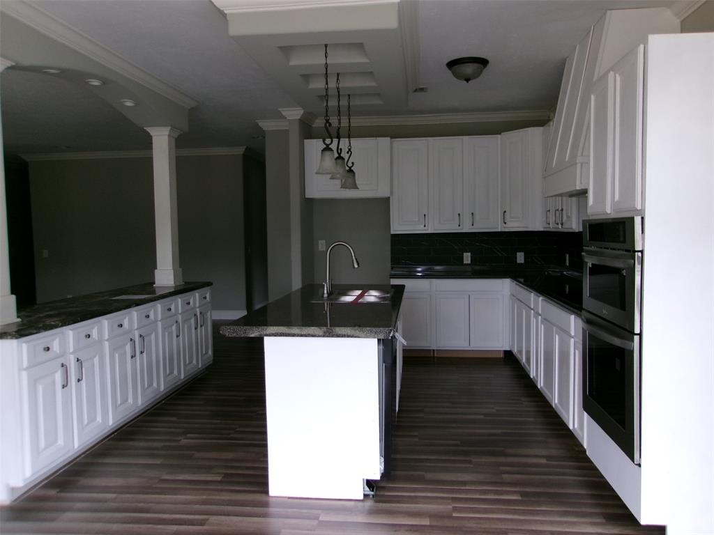 810 Williams Road Converse, LA 71419 - Photo 4 of 15 a kitchen with wooden cabinets and a sink