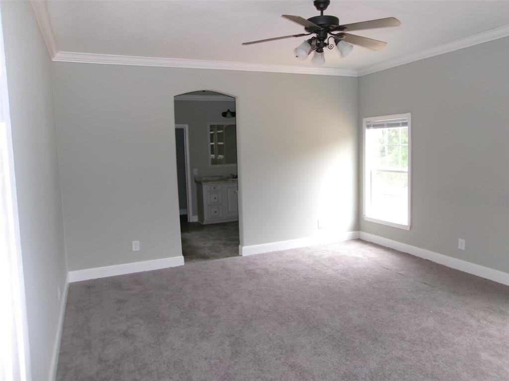 810 Williams Road Converse, LA 71419 - Photo 6 of 15 an empty room with chandelier fan and windows