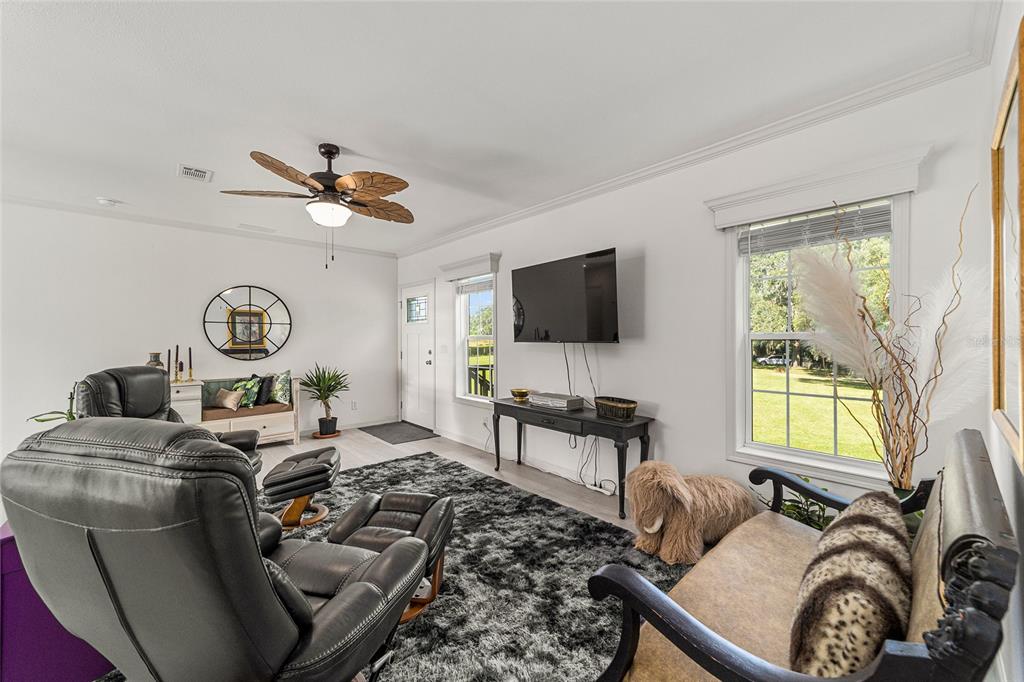 4520 Northwest 95th Avenue Road Ocala, FL 34482 - Photo 21 of 87 a living room with furniture a window and a flat screen tv