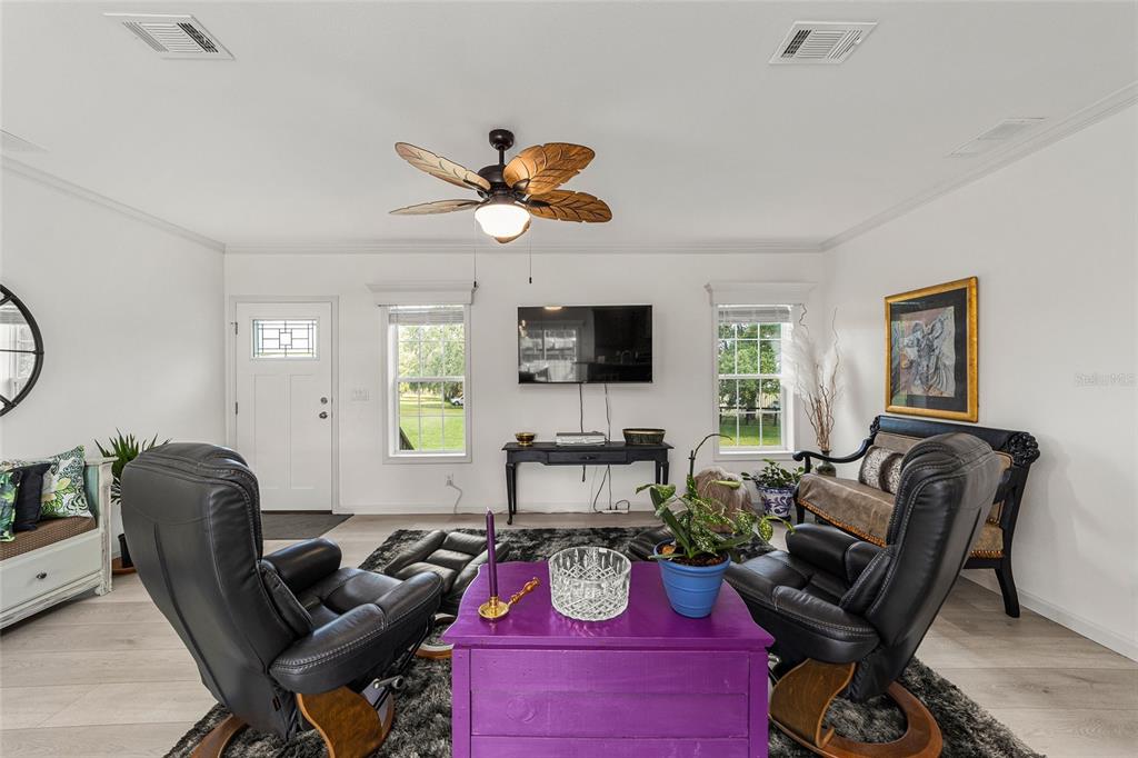 4520 Northwest 95th Avenue Road Ocala, FL 34482 - Photo 22 of 87 a living room with furniture a flat screen tv and a window