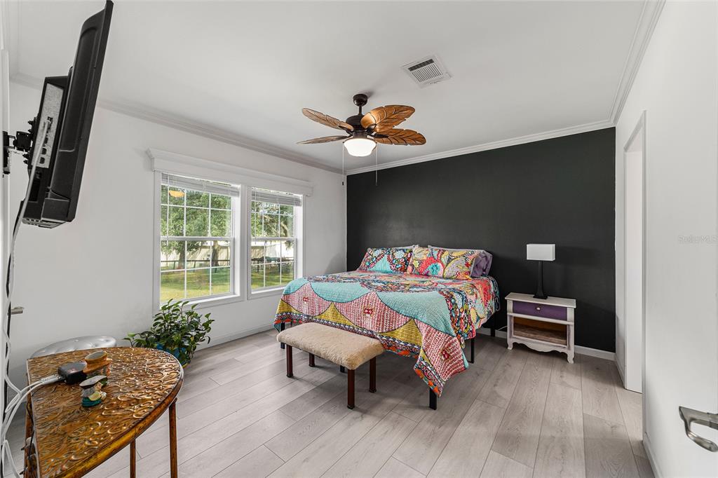 4520 Northwest 95th Avenue Road Ocala, FL 34482 - Photo 24 of 87 a bedroom with a bed and wooden floor