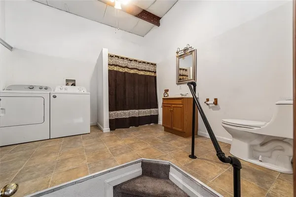 a bedroom with a bed next to a window