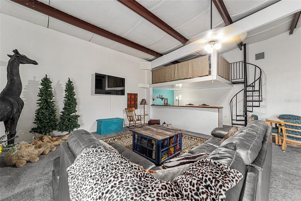 4520 Northwest 95th Avenue Road Ocala, FL 34482 - Photo 46 of 87 a living room with furniture a flat screen tv and a table